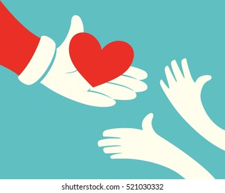 Close up of Santa claus hand holding red heart and hands of children on green background