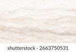 A close up view of a beige and white travertine stone surface with natural wavy patterns and granular texture.