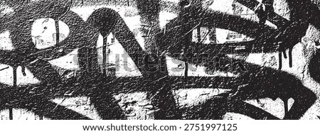 Close-up of black graffiti tags and drips on a rough, textured concrete wall