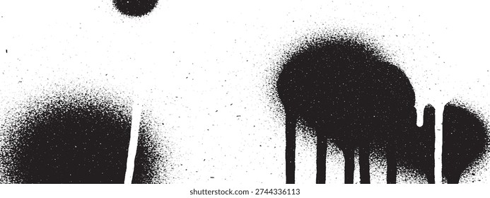 Close-up of black spray paint marks, including drips and splatters, creating an abstract and grunge texture on a clean white surface.