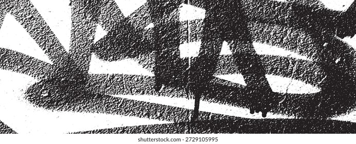 Close-up of black spray paint strokes and drips on a white surface, creating a raw and textured graffiti effect.