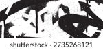 A close-up of a black and white graffiti artwork featuring bold, abstract shapes and dripping paint, creating a raw and urban aesthetic.