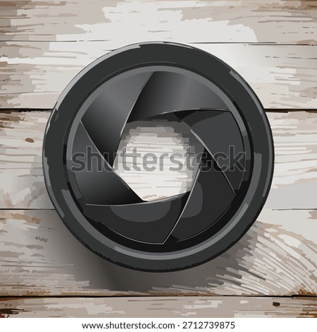 Close-up of a camera lens aperture against a textured wooden surface. The image features a metallic black aperture shape and a neutral-toned wooden backdrop. The lighting is bright and even.