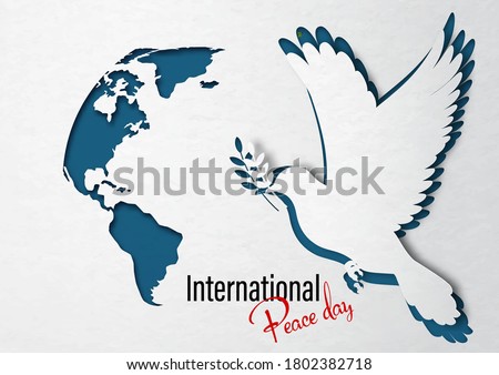 Closeup dove peace with a part of world map in paper cut out style and International Peach Day lettering on white paper pattern and navy blue background.