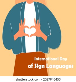 
Close-up girl shows a heart with her hands. Inscription International Day of Sign Languages. Vector flat illustration