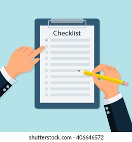 Close-up Of A Person's Hand Marking On Checklist With Pencil. Businessman hands holding clipboard with checklist and pencil.