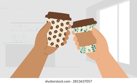 Close-up of two people holding up paper coffee cups with bean and leaf patterns for a toast in a bright kitchen background.