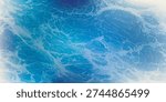 Close-up view of a blue water surface with intricate patterns of ripples and light reflections, creating an abstract and dynamic texture.