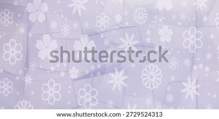 A close-up view of a fabric or paper surface adorned with an array of white floral and snowflake-like patterns, set against a gentle lavender hue.