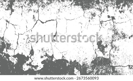 A close-up view of a grey and white textured surface with prominent cracks and distressed areas.