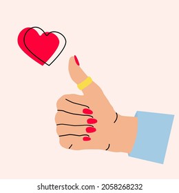 A close-up of a woman's hand with a manicure shows a sign - a thumb raised up. Place for text