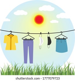 Clothes and face mask hanging in sun to kill COVID-19 coronavirus. Idea for new normal lifestyle on COVID-19 pandemic, protection, prevention and awareness concept.