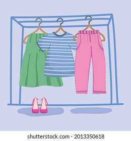 clothes hang on a shelf and shoes