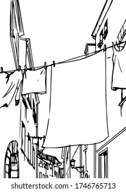 Clothes on clothesline in a narrow lane street