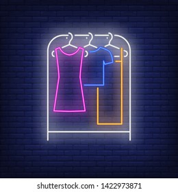 Clothes on rack neon sign. Shopping, fashion, garment. New collection concept. Vector illustration in neon style for advertising, online shopping, fashion show