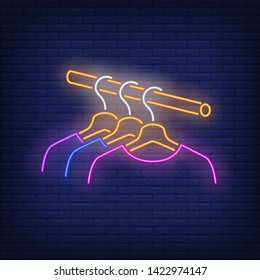 Clothes on rail neon sign. Shopping, fashion, garment. New collection concept. Vector illustration in neon style for advertising , online shopping, fashion show