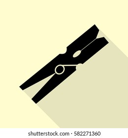 Clothes peg sign. Black icon with flat style shadow path on cream background.