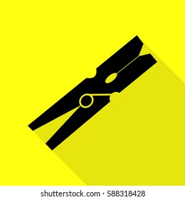 Clothes peg sign. Black icon with flat style shadow path on yellow background.
