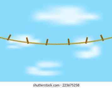 Clothespins on rope and blue sky