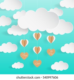 Cloud with hanging origami heart paper on green background and blank space for text 