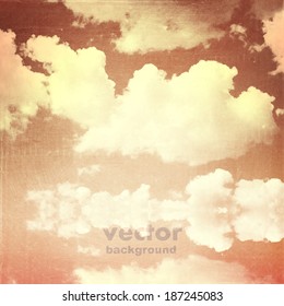 clouds on a textured vintage paper vector background, with grunge stains