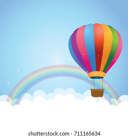 Cloudscape with rainbow and hot air balloon