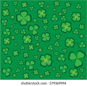 Clover background with green shamrocks and four-leaf clovers for luck