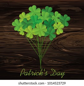 Clover bouquet on sticks. Greeting otkryka on St. Patrick's Day. Irish holiday. Free space for your text or advertisement. Vector illustration on a wooden background.