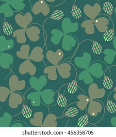 Clover flowers and leaves in green, beige and pink a seamless pattern on a green blue background.