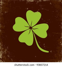 Clover with four leaves in brown background