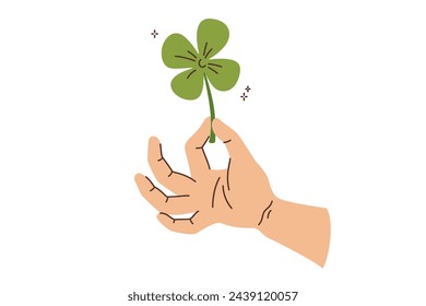 Trébol en la mano del hombre que recogió la planta e hizo el deseo de lograr la buena suerte y la fortuna. El trébol de cuarzo verde simboliza la festividad del Día de San Patricio prometiendo crecimiento o prosperidad