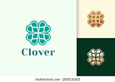 Clover leaf logo in abstract shape with green color represent lucky or herb