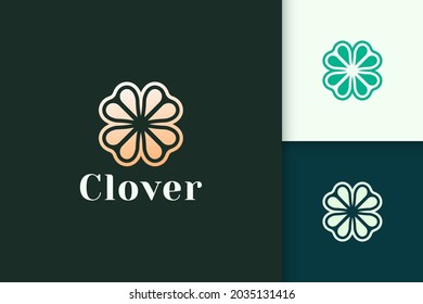 Clover leaf logo in luxury gold color represent lucky or herb