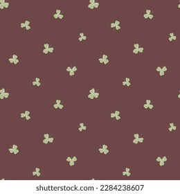 Clover leaf pattern vectpr background. Seamless backdrop with hand drawn shamrock motifs. Ditsy scattered botanical repeat in brown and green. Boho foliage loose all over print for summer, stationery,