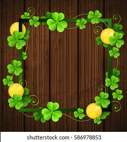 Clover leaves and golden coins in green frame on a wooden background. Design for St. Patrick's day.