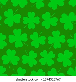 Clover leaves seamless pattern. St. Patrick's Day green background with shamrock or clover leaves. Happy Saint Patricks Day symbol.  Colorful flat seamless pattern with stylized clover. Vector.