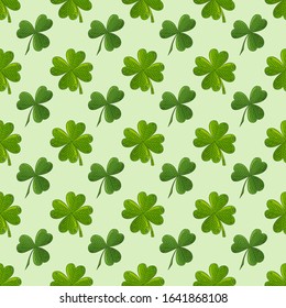 Clover pattern. Shamrock St. Patricks background. Holiday irish wallpaper. Green clover leaves isolated on light green texture. Seamless pattern traditional irish plants. 