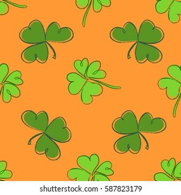 Clover seamless pattern. Clover pattern with three and four leaf green on orange background. St. Patrick's Day hand-drawn doodle style clover endless repeat backdrop, texture, wallpaper. Luck symbol