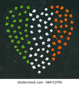 Clovers heart for St. Patrick's Day. Irish Flag. Ireland Flag Made Of Clover Laef. Chalkboard Background.