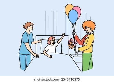 Clown entertains sick girl lying in bed in hospital to improve mood child suffering from illness. Animator gives flowers and balloons to patient at children hospital in need of psychological support