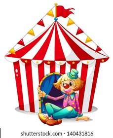  clown sitting in front of a red circus tent on a white background