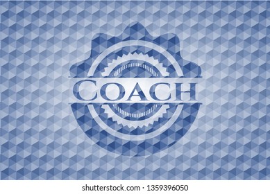 Coach blue emblem or badge with abstract geometric pattern background.