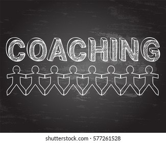 Coaching hand drawn text and cut out paper people chain on blackboard background