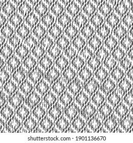 Coarse fabric, in black and white, patterned with diamonds. Rough cotton towel.