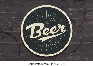 Coaster for beer with hand drawn lettering Beer. Monochrome vintage drawing for bar, pub and beer themes. Black circle for placing a beer mug or a bottle over it with lettering. Vector Illustration