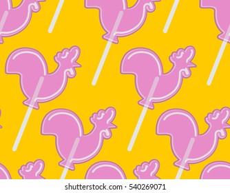 Cockerel candy seamless pattern. Caramel background. Sweet Christmas ornament. lollipop rooster sign for new year. lollipops Cock texture. Russian traditional folk sweets
