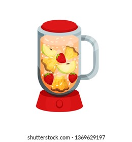 Cocktail with apple, pineapple, strawberry in red blender.
