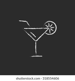Cocktail glass hand drawn in chalk on a blackboard vector white icon isolated on a black background.