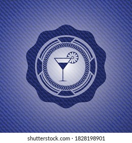 cocktail glass icon inside badge with denim texture. 