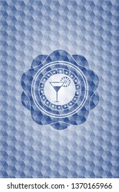 cocktail glass icon inside blue badge with geometric pattern background.